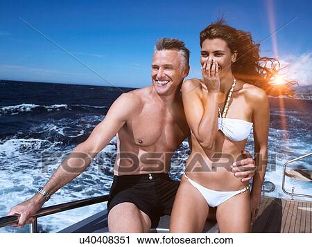 Stock Image - Couple on a Boat in swimwear. Fotosearch