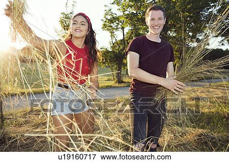 Couple playing with hay in sunshine, Wilhelminenberg, Vienna, Austria View Large Photo Image Stock Photo - Couple playing with hay in sunshine, Wilhelminenberg, Vienna, Austria. Fotosearch