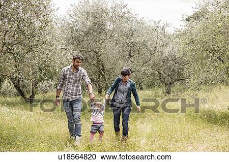 Couple running with toddler girl in garden, Florence, Italy View Large Photo Image Stock Image - Couple running with toddler girl in garden, Florence, Italy. Fotosearch