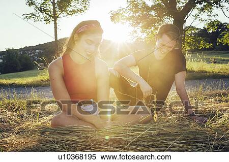 Couple sitting on loose hay, Wilhelminenberg, Vienna, Austria View Large Photo Image Stock Photography - Couple sitting on loose hay, Wilhelminenberg, Vienna, Austria. Fotosearch