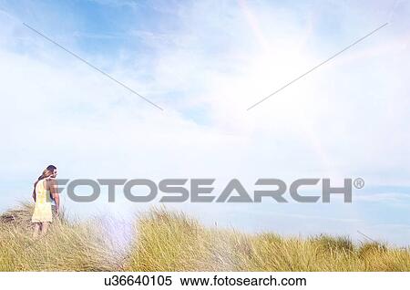 Stock Photography - Couple Standing in Meadow. Fotosearch