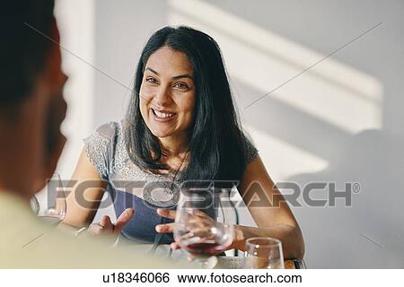 Stock Photograph - Couple talking at mealtime in restaurant. Fotosearch