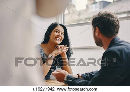 Stock Image - Couple talking in restaurant. Fotosearch