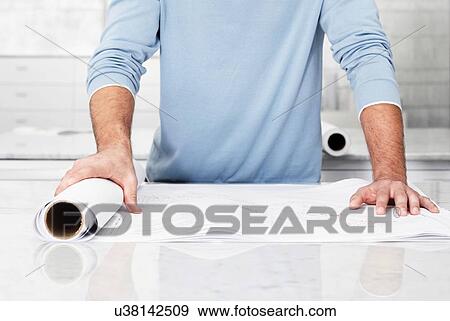 Cropped photo of architect holding plans in office View Large Photo Image Stock Photo - Cropped photo of architect holding plans in office. Fotosearch