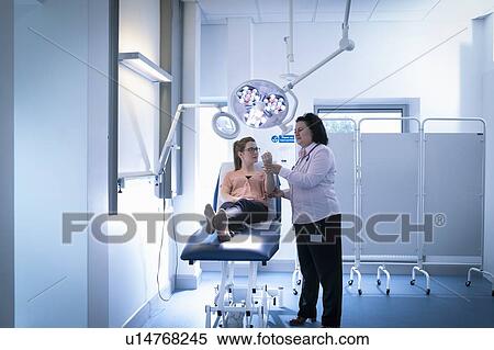 Doctor inspecting patient's hand in intensive care unit in hospital setting View Large Photo Image Stock Photography - Doctor inspecting patient's hand in intensive care unit in hospital setting. Fotosearch