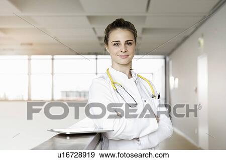 Stock Photo - Doctor taking break at corridor in hospital. Fotosearch