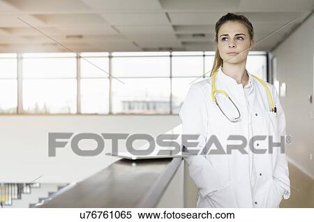 Doctor taking break at corridor in hospital View Large Photo Image Stock Photography - Doctor taking break at corridor in hospital. Fotosearch