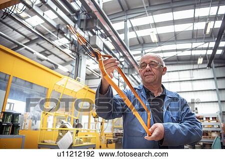 Electrical engineer inspecting copper windings in electrical engineering factory View Large Photo Image Stock Image - Electrical engineer inspecting copper windings in electrical engineering factory. Fotosearch