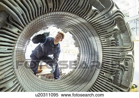 Electrical engineer inspecting winding on generator stator in electrical engineering factory View Large Photo Image Stock Photography - Electrical engineer inspecting winding on generator stator in electrical engineering factory. Fotosearch