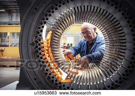 Electrical engineer installing copper windings into generator stator in electrical engineering factory View Large Photo Image Stock Image - Electrical engineer installing copper windings into generator stator in electrical engineering factory. Fotosearch