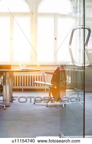 Stock Image - Empty conference room with laptop on table. Fotosearch