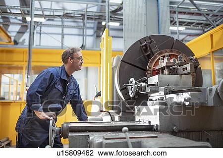 Engineer operating lathe in electrical engineering factory View Large Photo Image Stock Image - Engineer operating lathe in electrical engineering factory. Fotosearch