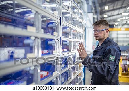 Engineer operating tool and parts vending machine in electrical engineering factory View Large Photo Image Stock Image - Engineer operating tool and parts vending machine in electrical engineering factory. Fotosearch
