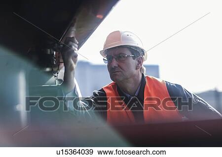 Stock Photo - Engineer working at port. Fotosearch