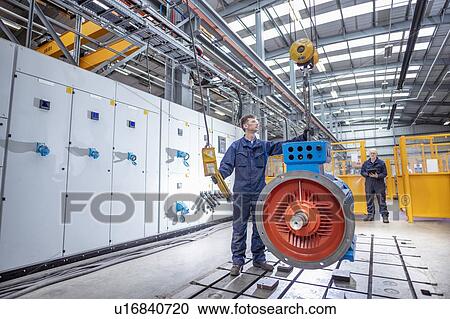 Engineers craning generator on to test bed in electrical engineering factory View Large Photo Image Stock Image - Engineers craning generator on to test bed in electrical engineering factory. Fotosearch