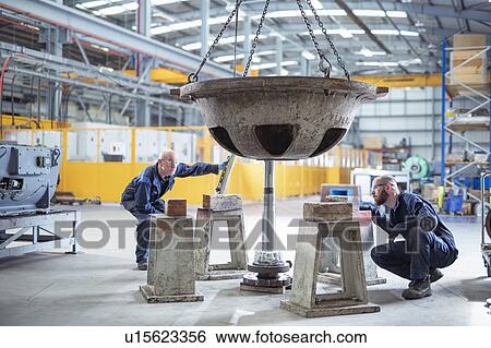 Engineers fitting spindle to pump parts in electrical engineering factory View Large Photo Image Stock Photograph - Engineers fitting spindle to pump parts in electrical engineering factory. Fotosearch