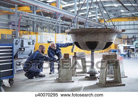 Engineers fitting spindle to pump parts in electrical engineering factory View Large Photo Image Stock Photography - Engineers fitting spindle to pump parts in electrical engineering factory. Fotosearch