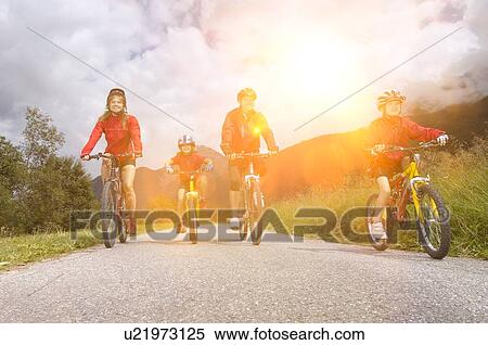Family cycling in countryside View Large Photo Image Stock Photography - Family cycling in countryside. Fotosearch