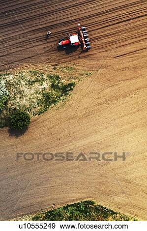 Farmer and tractor with seeder, aerial view View Large Photo Image Stock Photo - Farmer and tractor with seeder, aerial view. Fotosearch