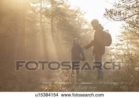 Father and son talking in forest, Finland View Large Photo Image Picture - Father and son talking in forest, Finland. Fotosearch