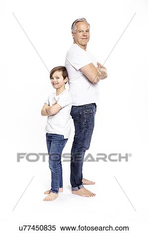 Stock Photography - Father and son with arms crossed, white background. Fotosearch