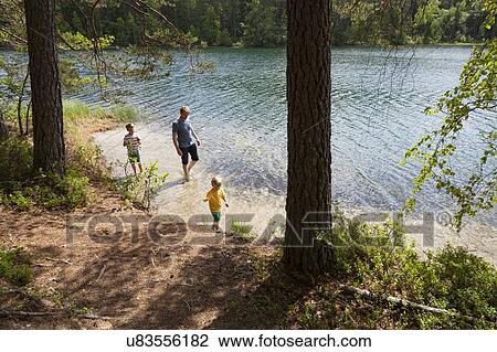 Father and sons playing near lake, Finland View Large Photo Image Stock Image - Father and sons playing near lake, Finland. Fotosearch
