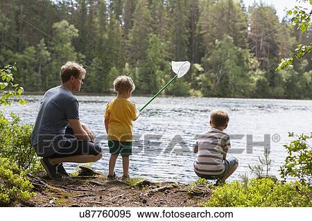 Father and sons playing with fish net by lake, Finland View Large Photo Image Stock Photography - Father and sons playing with fish net by lake, Finland. Fotosearch