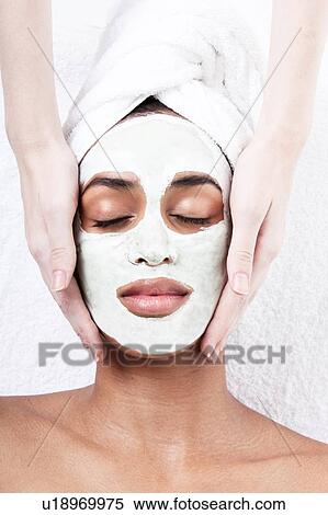 Stock Photography - Female having face rub mask in spa. Fotosearch