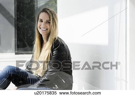 Female student taking break at corridor in campus View Large Photo Image Stock Photography - Female student taking break at corridor in campus. Fotosearch