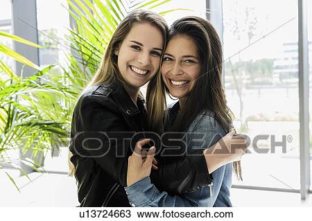 Female students hugging in campus View Large Photo Image Stock Image - Female students hugging in campus. Fotosearch
