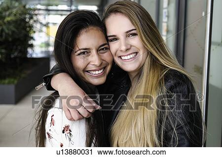 Female students hugging in campus View Large Photo Image Stock Image - Female students hugging in campus. Fotosearch