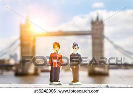 Figurines of police officer and coldstream guard with Tower Bridge in background View Large Photo Image Stock Photograph - Figurines of police officer and coldstream guard with Tower Bridge in background. Fotosearch