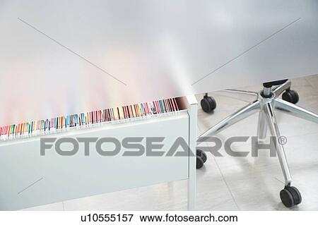 Stock Photo - File folders in drawer partly visible under metal cubicle wall. Fotosearch