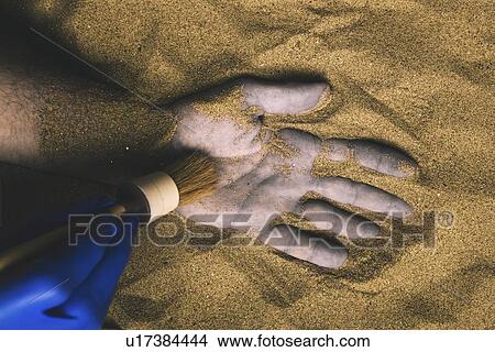 Forensic expert discovering body buried in sand View Large Photo Image Picture - Forensic expert discovering body buried in sand. Fotosearch