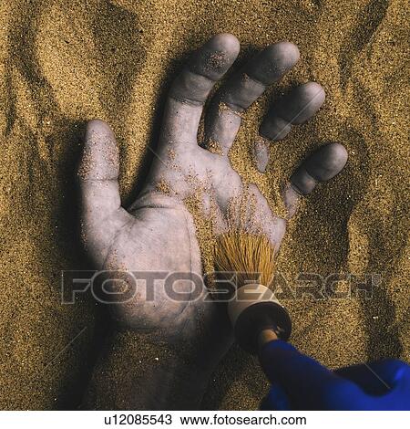 Stock Image - Forensic expert discovering body buried in sand. Fotosearch