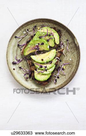 Fresh cut avocado on toasted bread with sprouts View Large Photo Image Stock Image - Fresh cut avocado on toasted bread with sprouts. Fotosearch