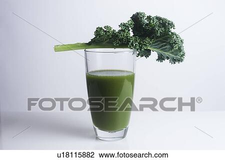 Fresh kale leaf and a glass of green juice View Large Photo Image Stock Image - Fresh kale leaf and a glass of green juice. Fotosearch