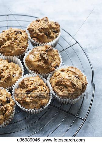 Stock Photograph - Freshly baked chocolate chips muffins on cooling tray. Fotosearch