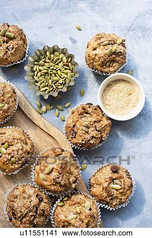 Stock Image - Freshly baked muffins with pumpkin seeds. Fotosearch