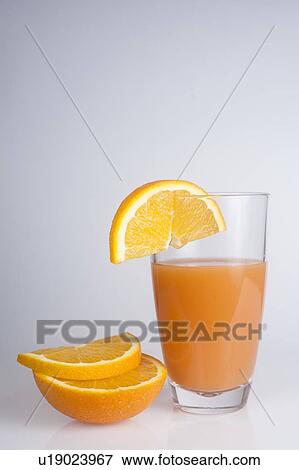 Freshly squeezed orange juice and orange slices View Large Photo Image Stock Photo - Freshly squeezed orange juice and orange slices. Fotosearch