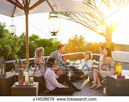 Friends Drinking together in balcony bar View Large Photo Image Stock Photo - Friends Drinking together in balcony bar. Fotosearch
