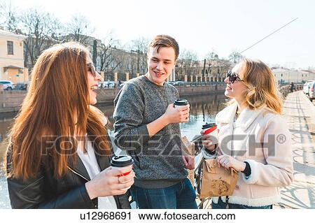 Friends having coffee by river, Saint Petersburg, Russia View Large Photo Image Stock Image - Friends having coffee by river, Saint Petersburg, Russia. Fotosearch
