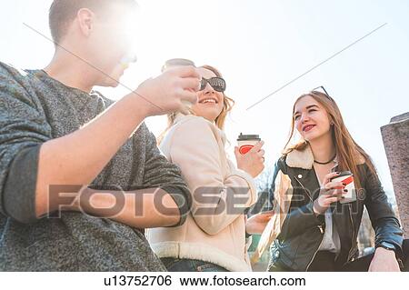 Friends having coffee by river View Large Photo Image Stock Photograph - Friends having coffee by river. Fotosearch