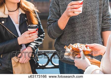 Friends having coffee by river View Large Photo Image Stock Photograph - Friends having coffee by river. Fotosearch