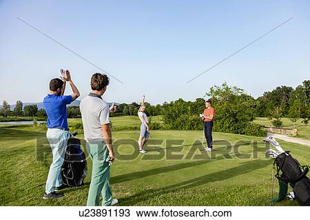 Friends playing golf on golf course View Large Photo Image Stock Image - Friends playing golf on golf course. Fotosearch