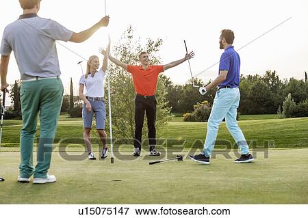 Friends playing golf on golf course View Large Photo Image Stock Photo - Friends playing golf on golf course. Fotosearch