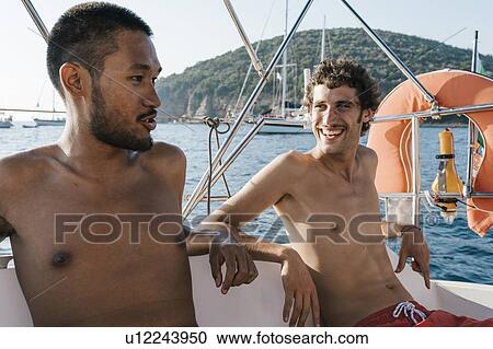 Friends relaxing on sailboat, Italy View Large Photo Image Stock Image - Friends relaxing on sailboat, Italy. Fotosearch