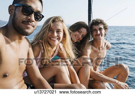 Friends relaxing on sailboat, Italy View Large Photo Image Stock Image - Friends relaxing on sailboat, Italy. Fotosearch
