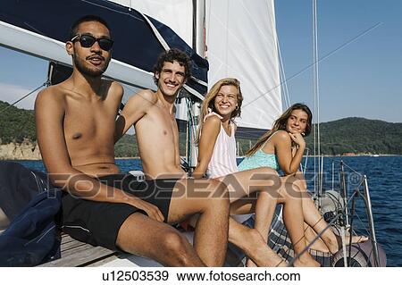 Friends relaxing on sailboat, Italy View Large Photo Image Stock Photo - Friends relaxing on sailboat, Italy. Fotosearch