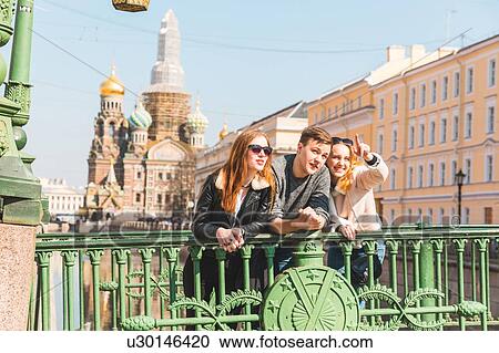 Friends sightseeing in city, Saint Petersburg, Russia View Large Photo Image Stock Image - Friends sightseeing in city, Saint Petersburg, Russia. Fotosearch